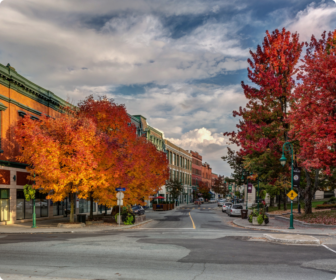 Downtown street lined with red and orange autumn trees